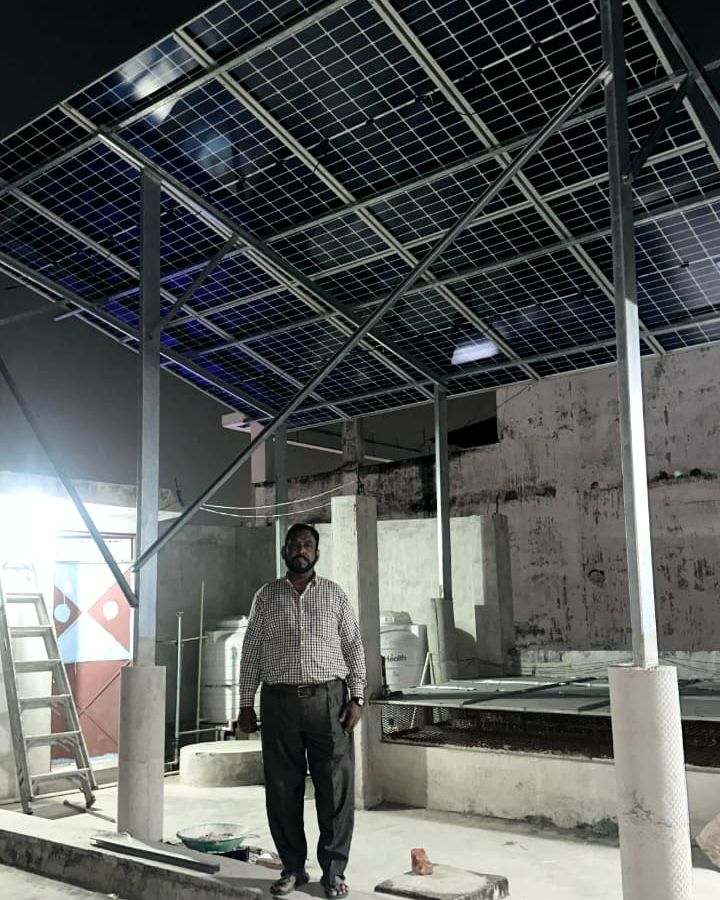 Abid with the rooftop solar system SolarSpot installed, Mahanagar, Lucknow