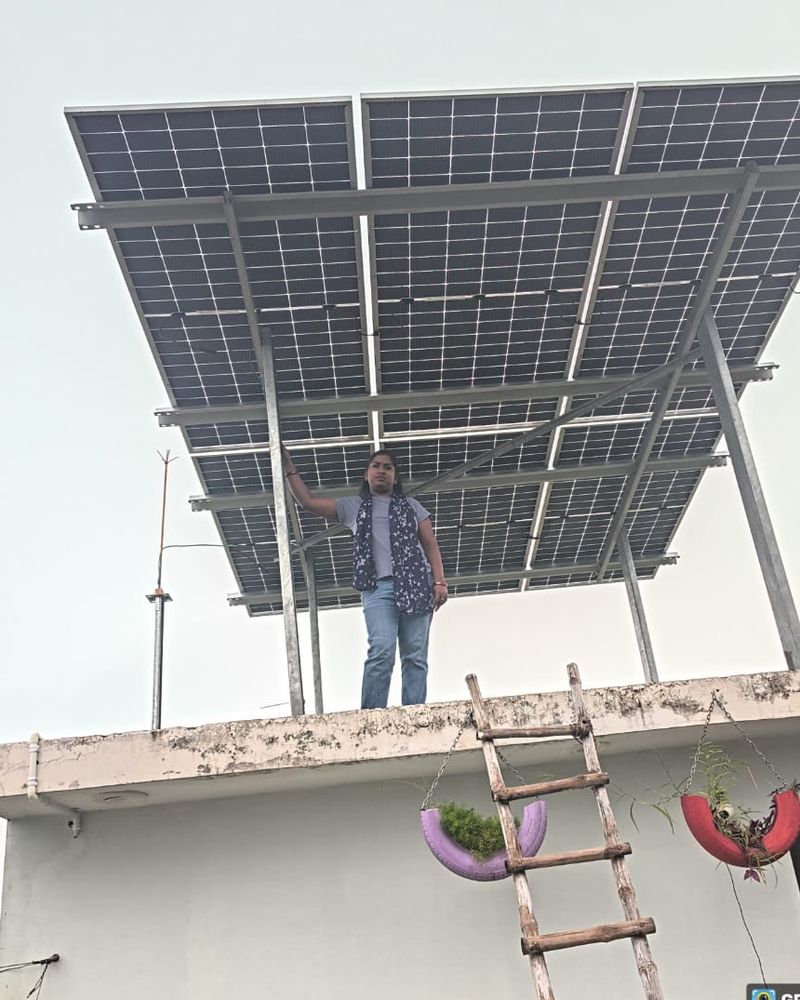 Deepti with the rooftop solar system SolarSpot installed, Tiwaripur, Lucknow