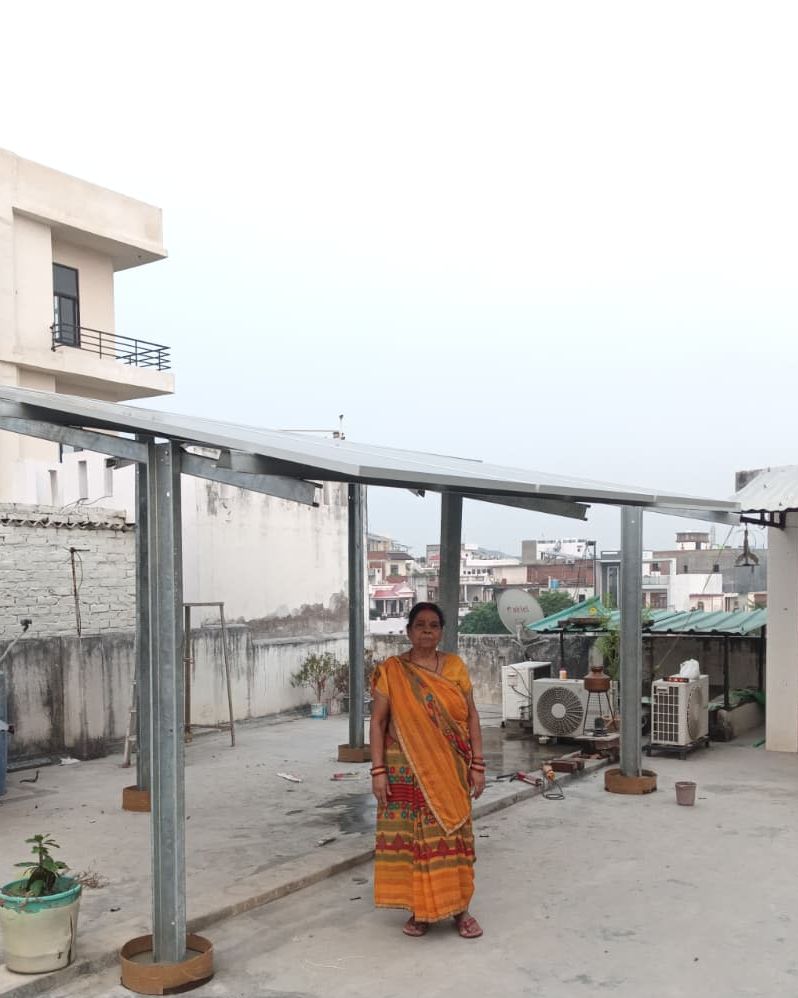 Munnu Gupta with the rooftop solar system SolarSpot installed, Alambagh, Lucknow