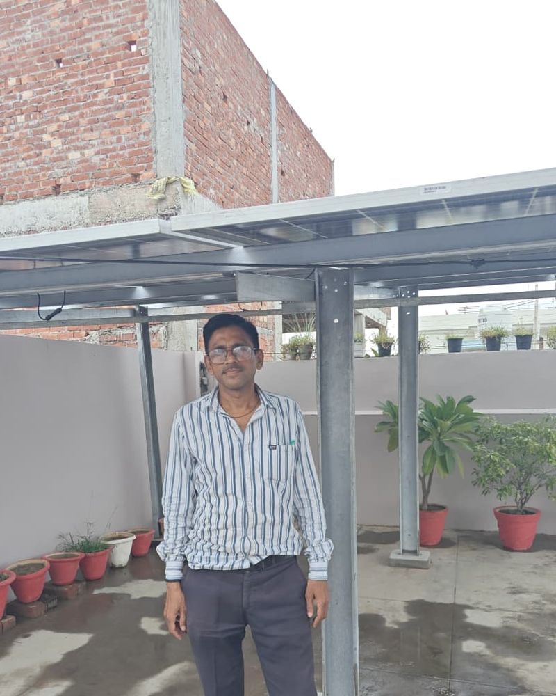 Santosh Rastogi with the rooftop solar system SolarSpot installed, Rastogi Nagar, Lucknow