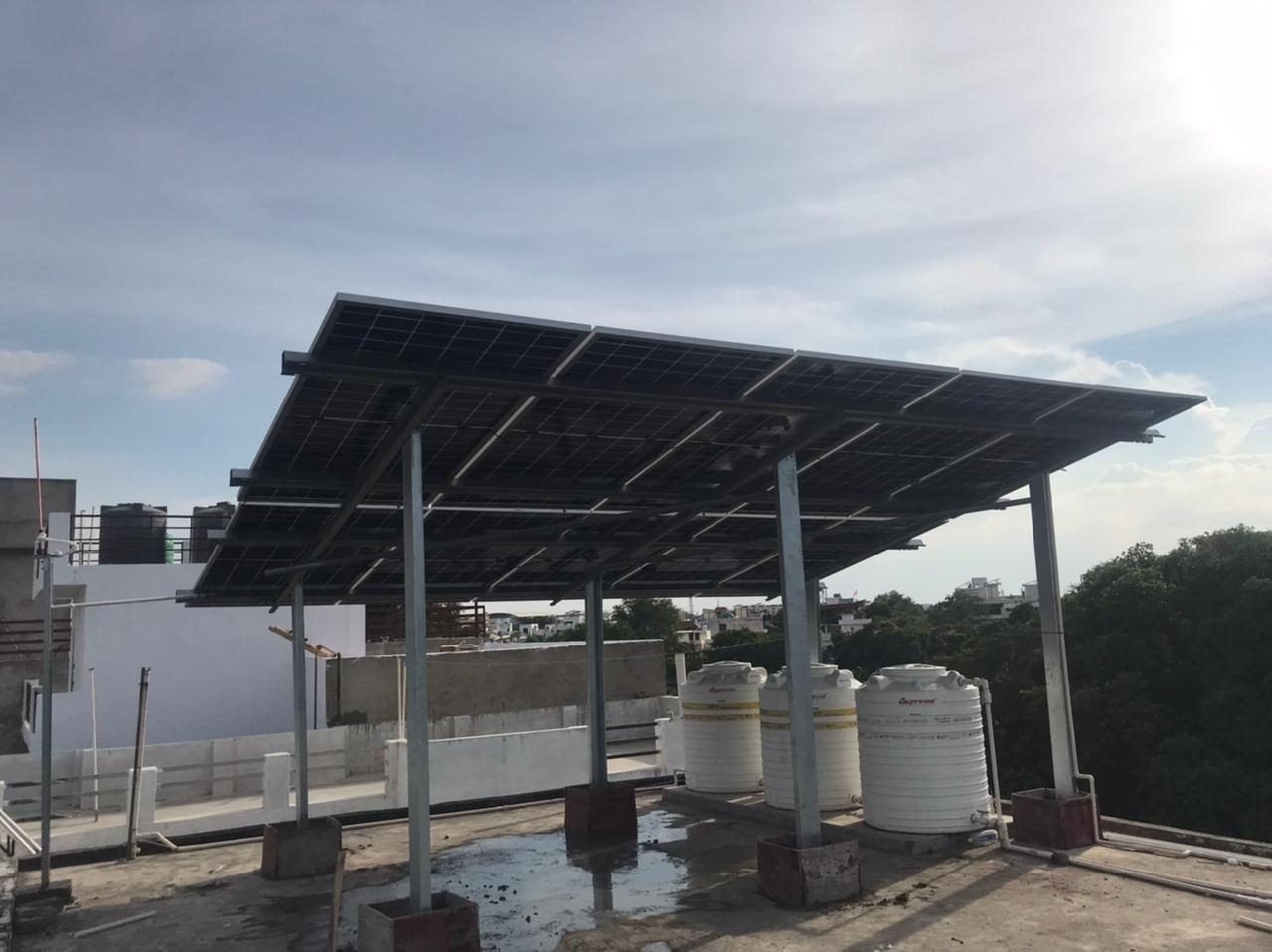 Elevated solar structure built over water tanks on a rooftop