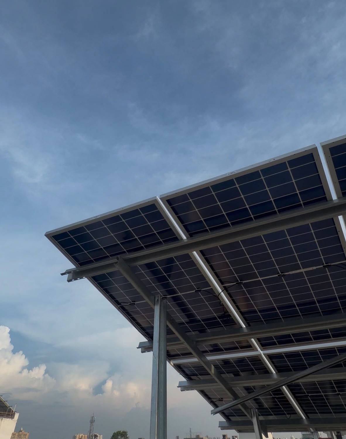 Bifacial solar panels on an elevated galvanized steel structure, seen from below